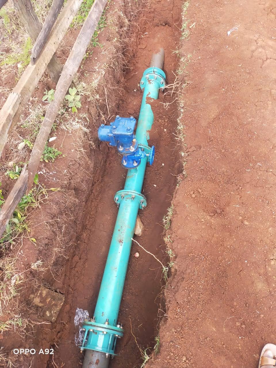 Water main pipe fitting installed in a trench